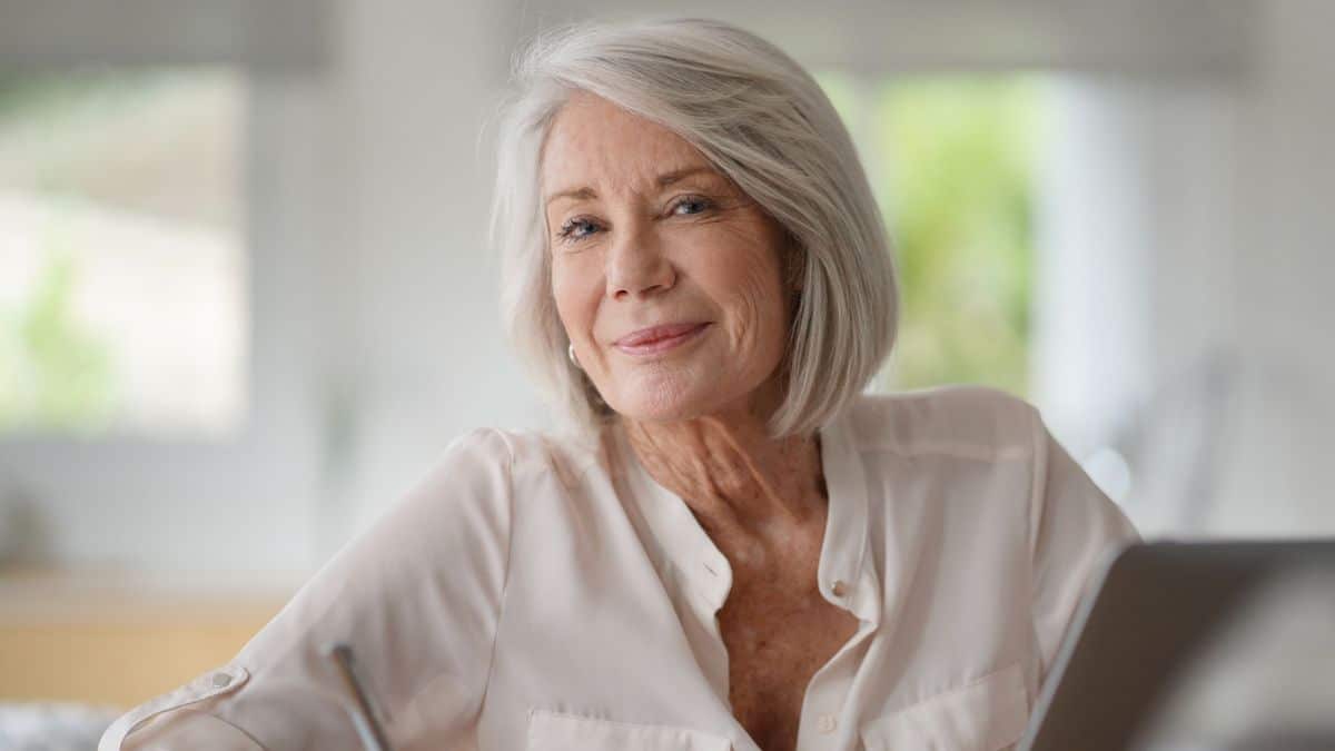 senior woman sitting at home working