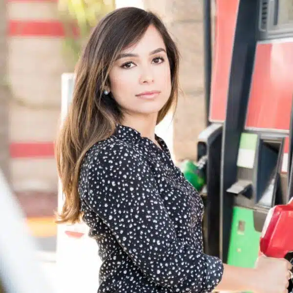 woman standing at the gas pump