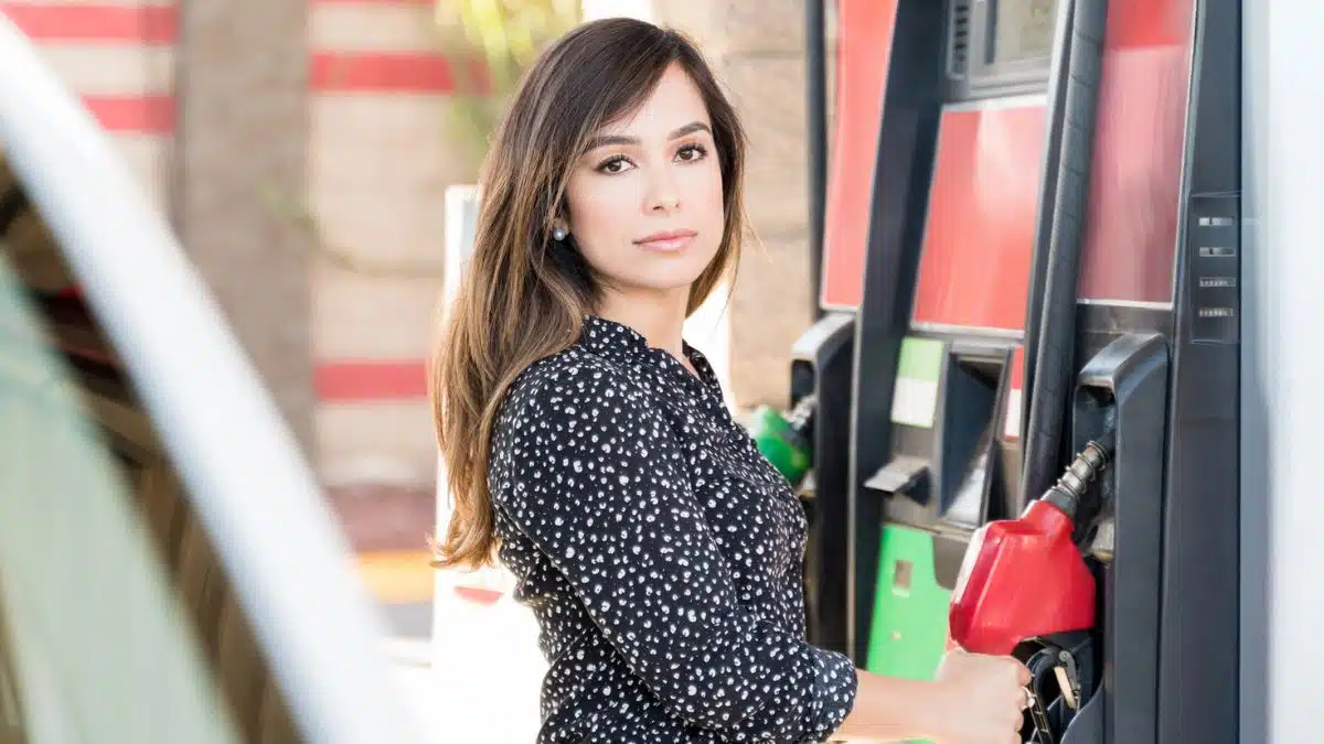 woman standing at the gas pump