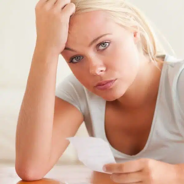 woman staring at receipts