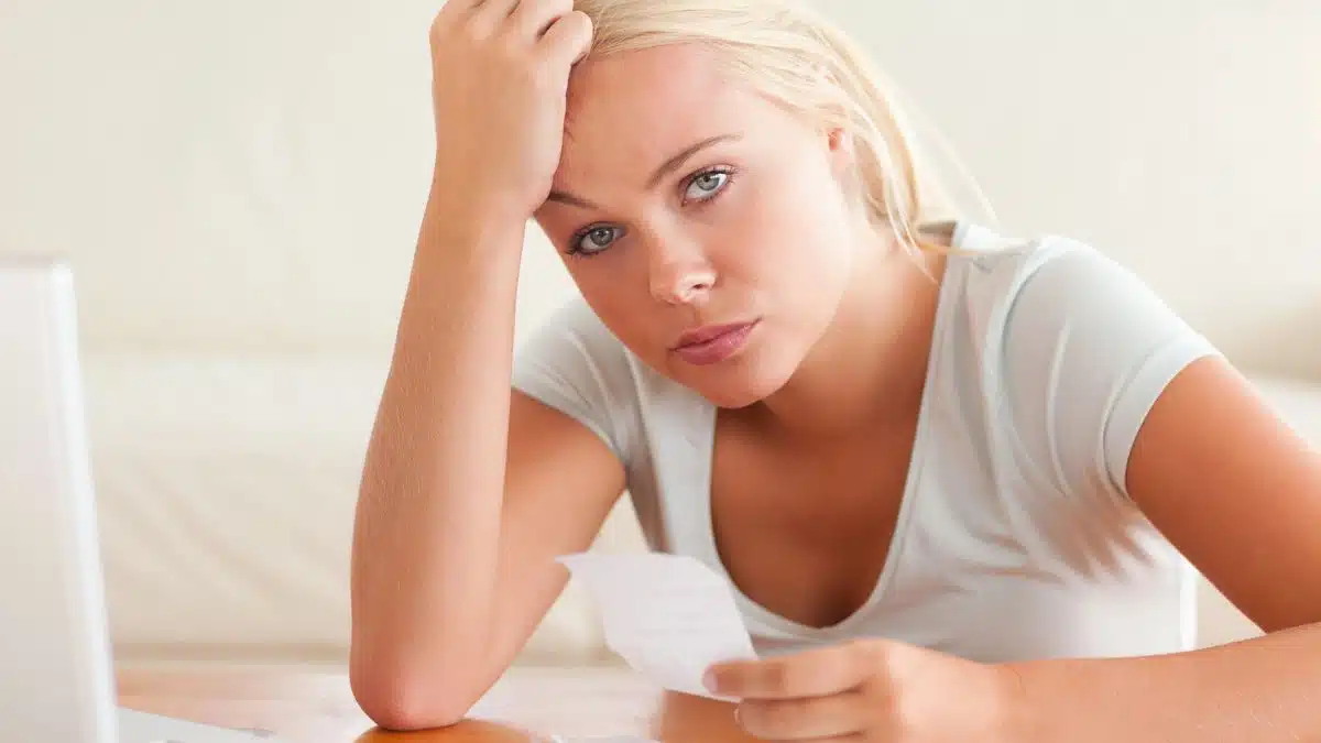 woman staring at receipts