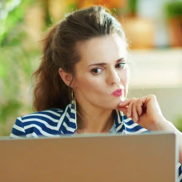 woman with laptop and thinking