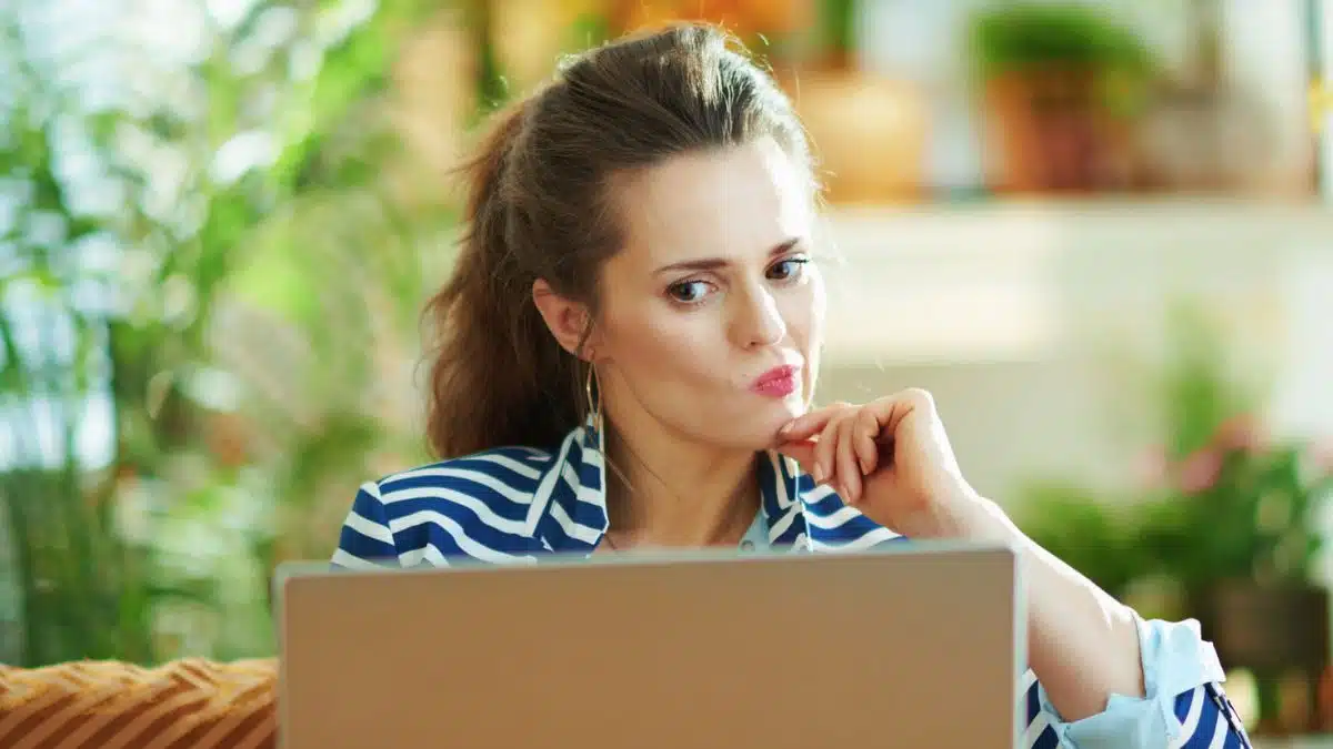 woman with laptop and thinking