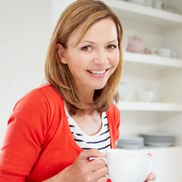 woman working from home holding coffee