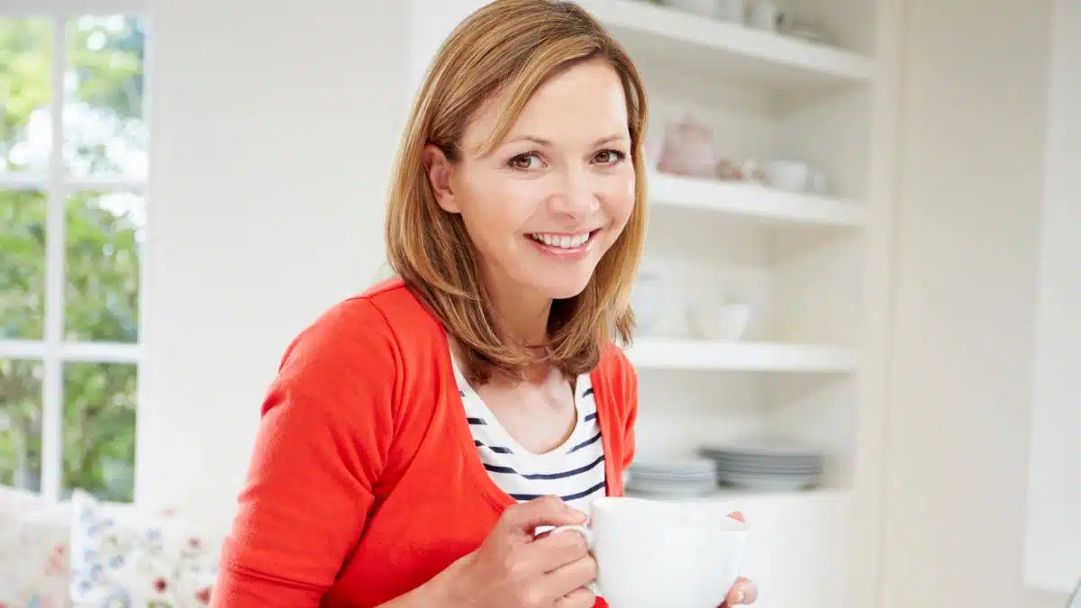 woman working from home holding coffee
