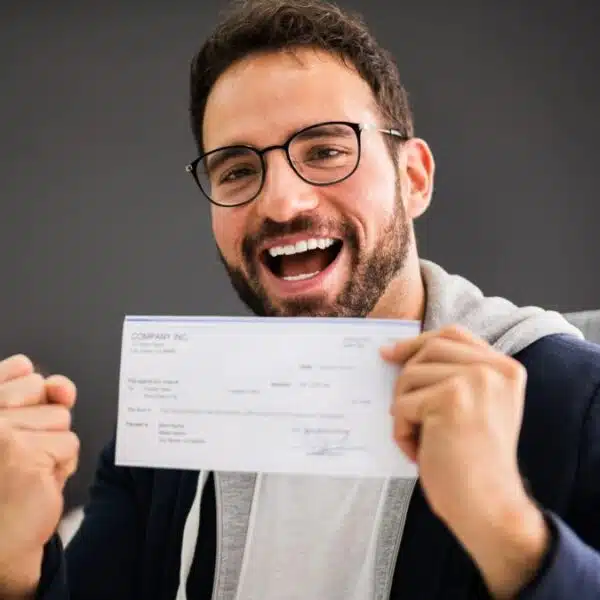 Man celebrating receiving his paycheck