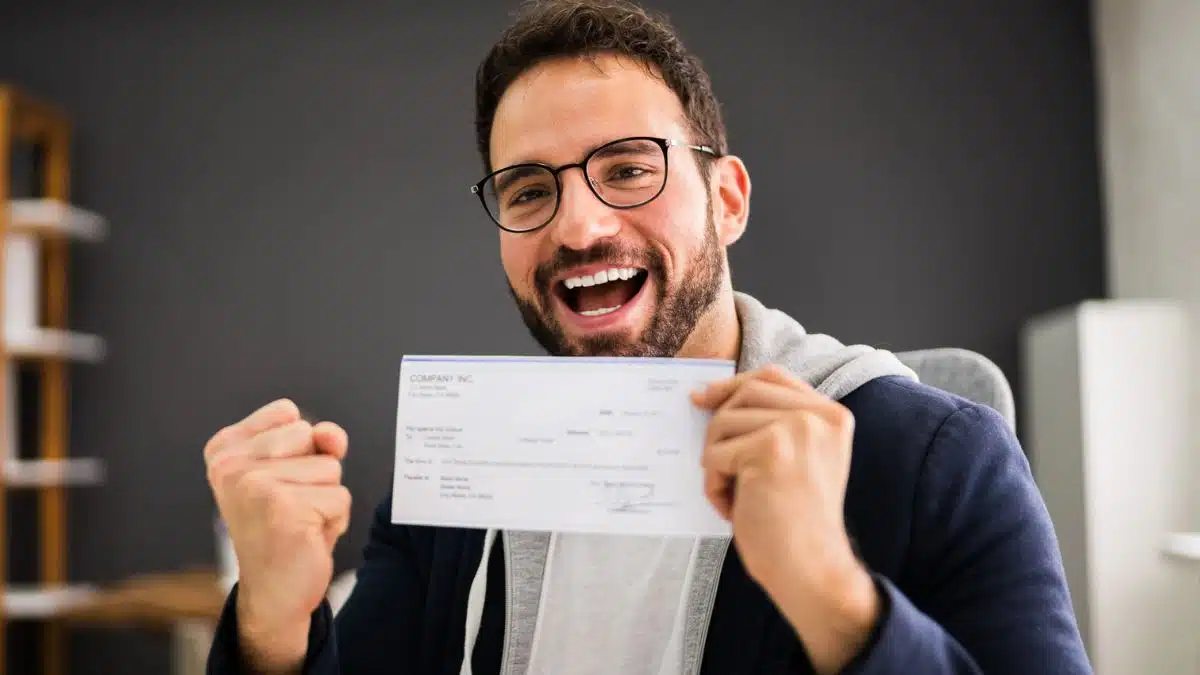 Man celebrating receiving his paycheck
