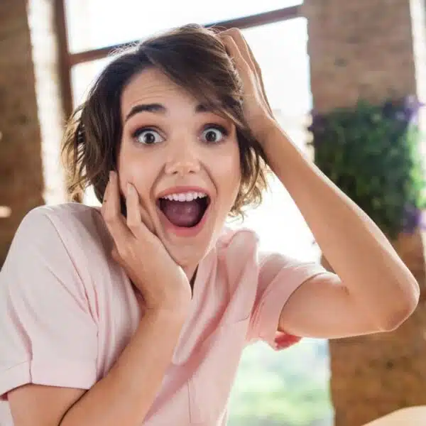 Woman shocked in front of her computer