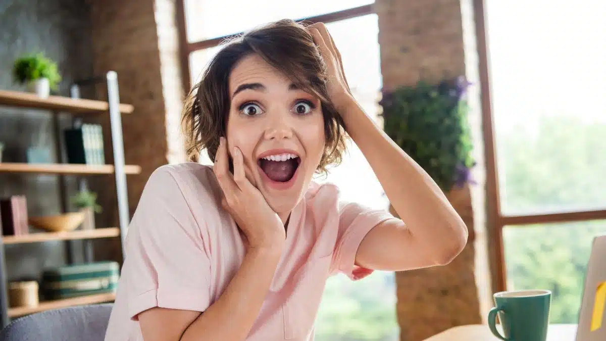 Woman shocked in front of her computer