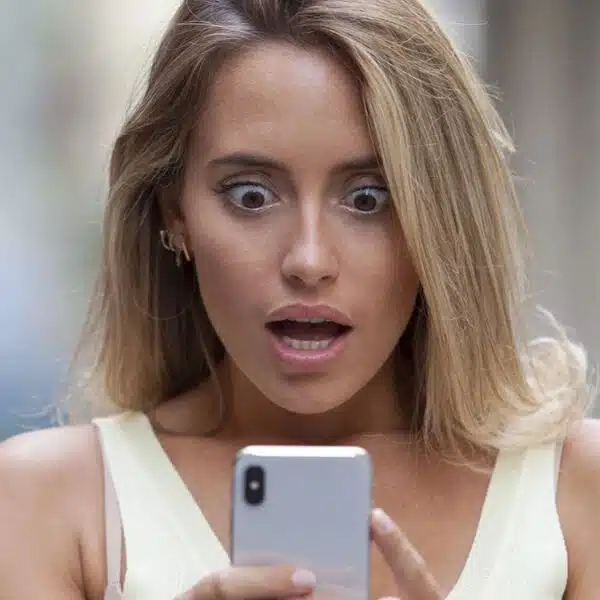 Woman shocked looking at her phone