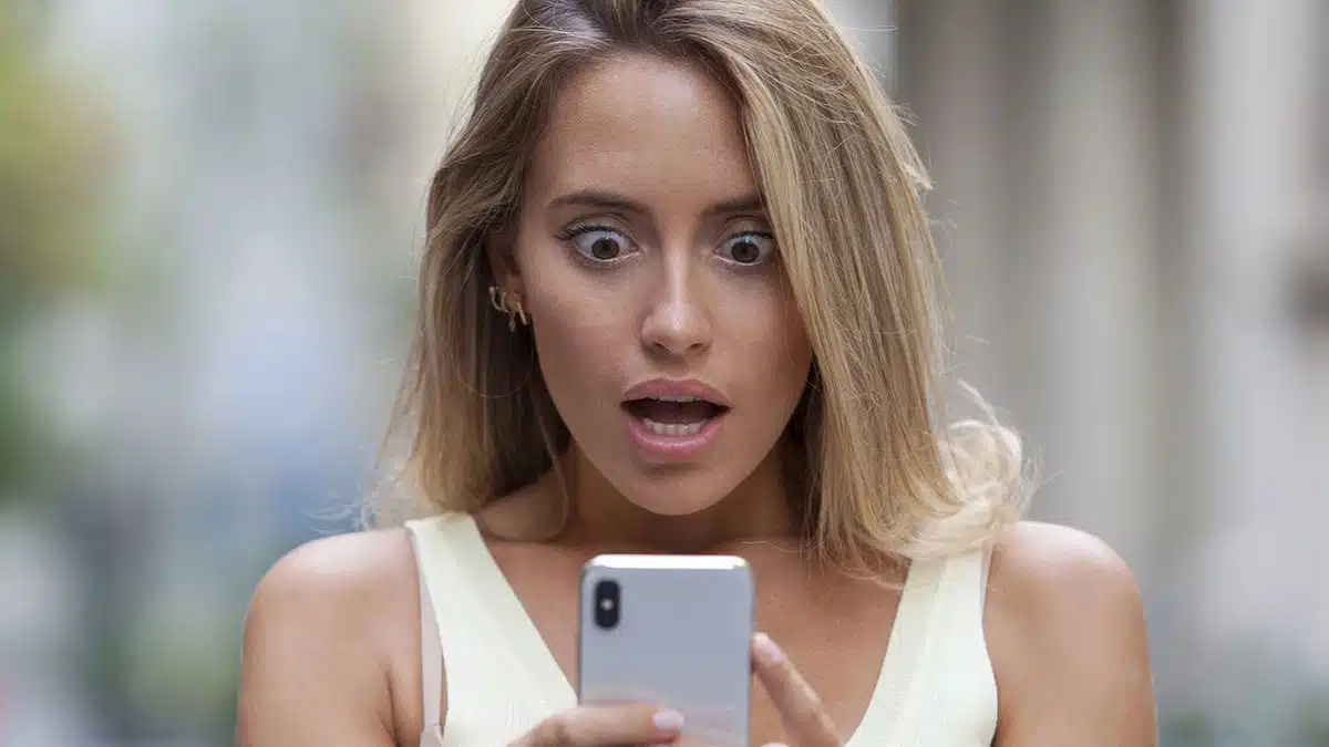 Woman shocked looking at her phone
