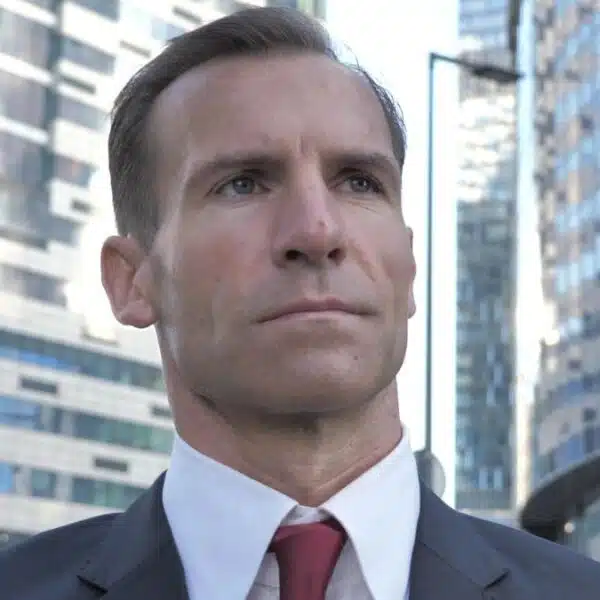 business man standing in front of buildings