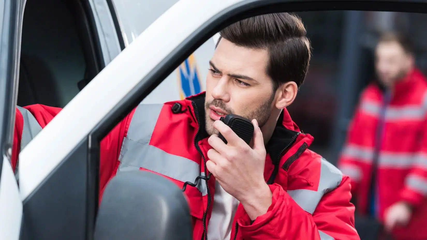 emt making a call on his walkie