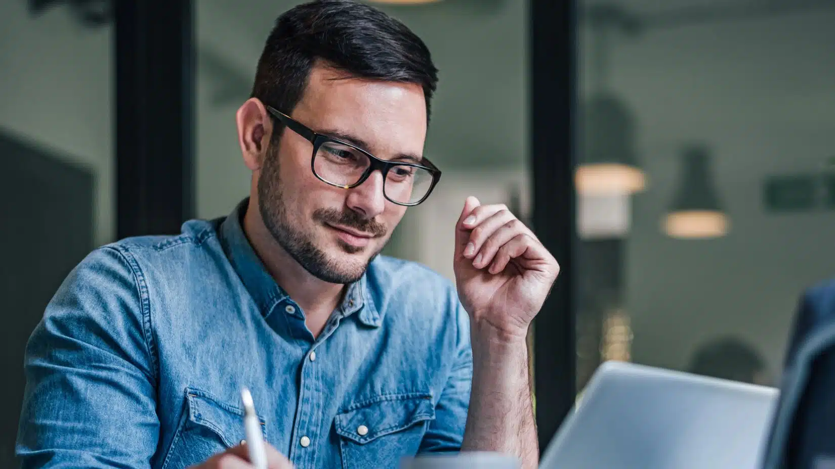man glasses working office
