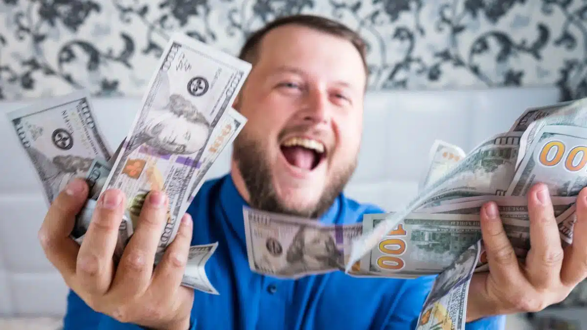 man holding cash a lot
