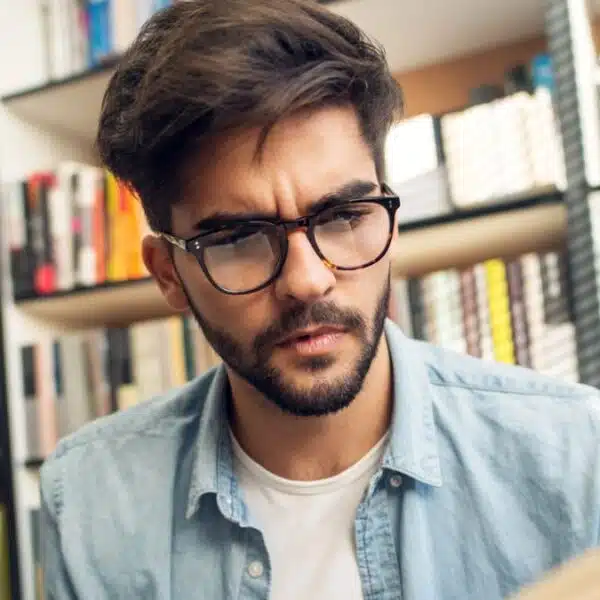man reading a book in the library