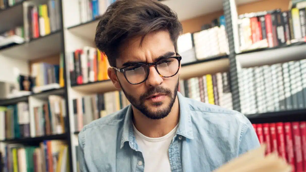 man reading a book in the library