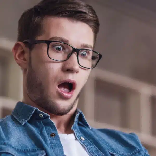 man shocked looking at his bank account