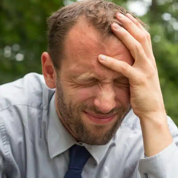 man stressed sitting outside