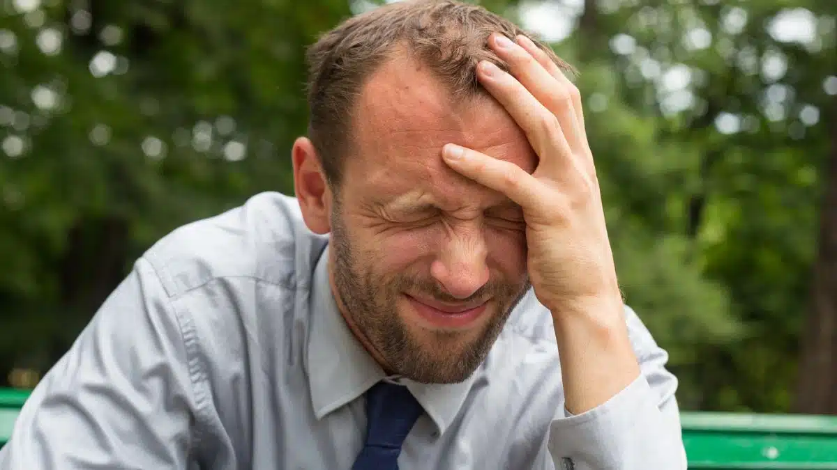 man stressed sitting outside