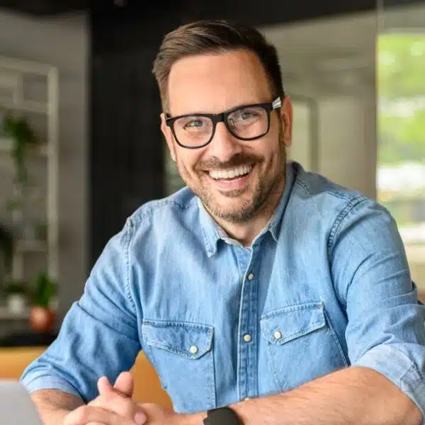man with glasses working from home