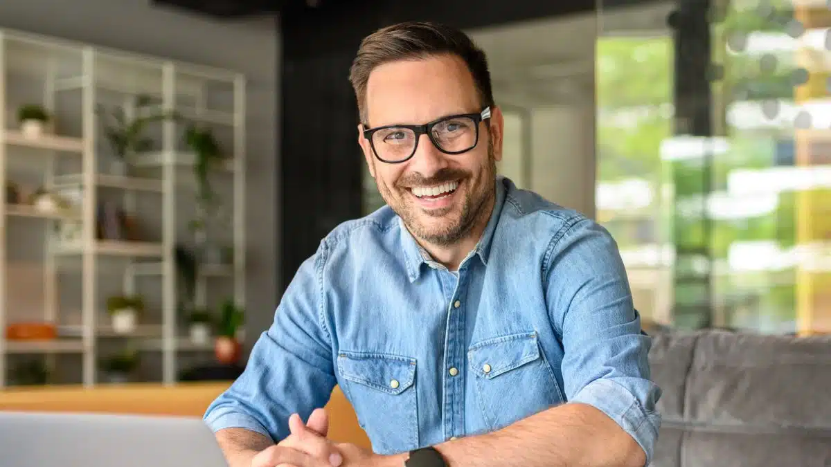 man with glasses working from home