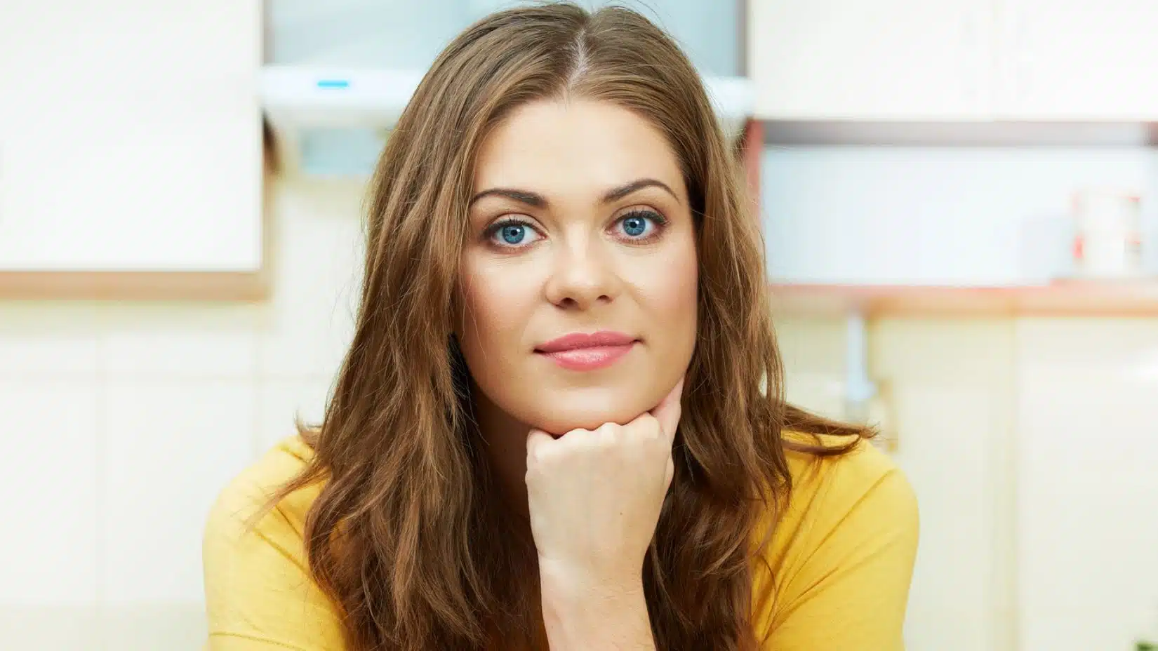 woman thinking in kitchen