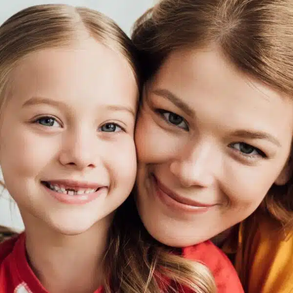 mom and daughter smiling