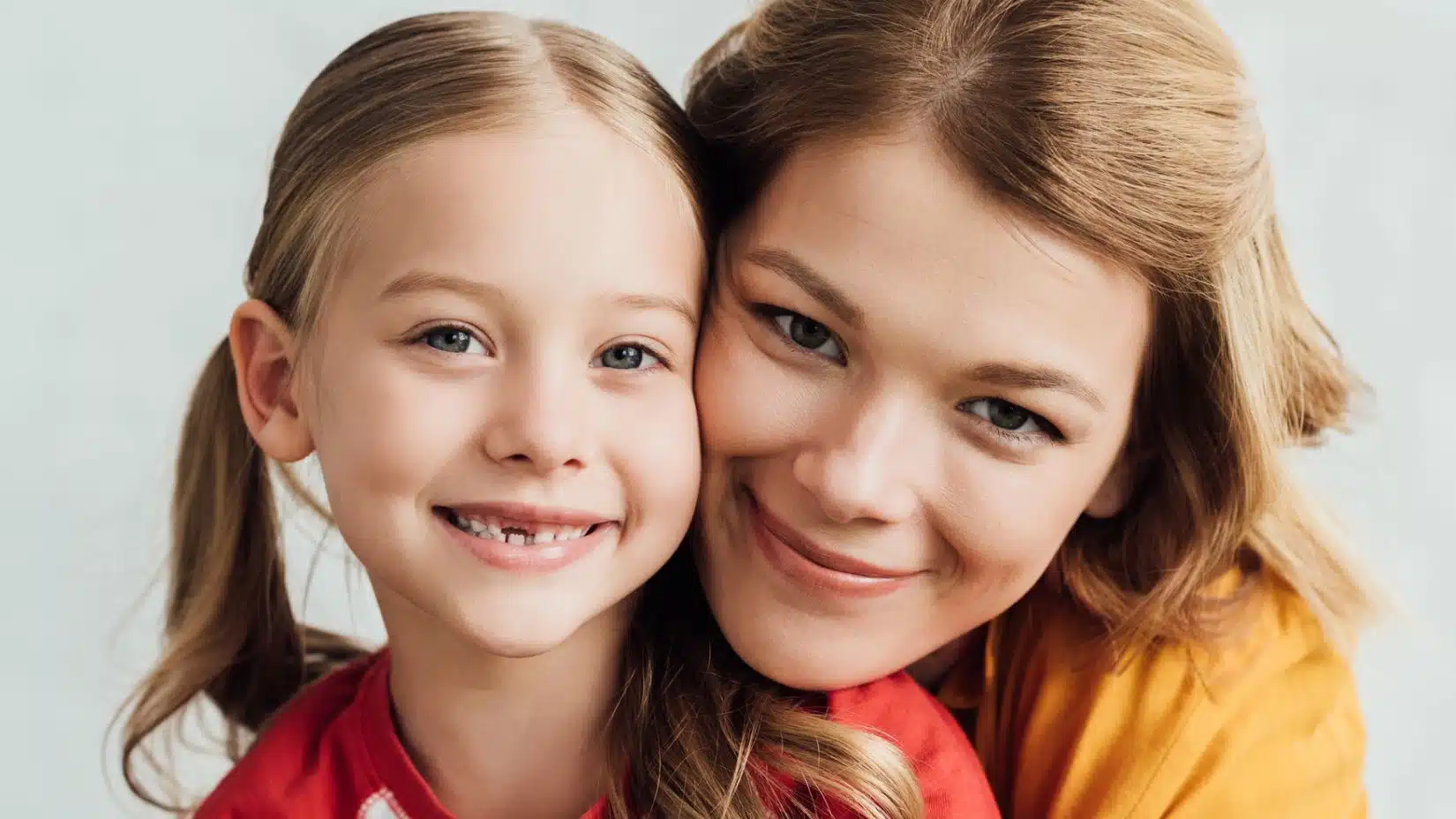 mom and daughter smiling