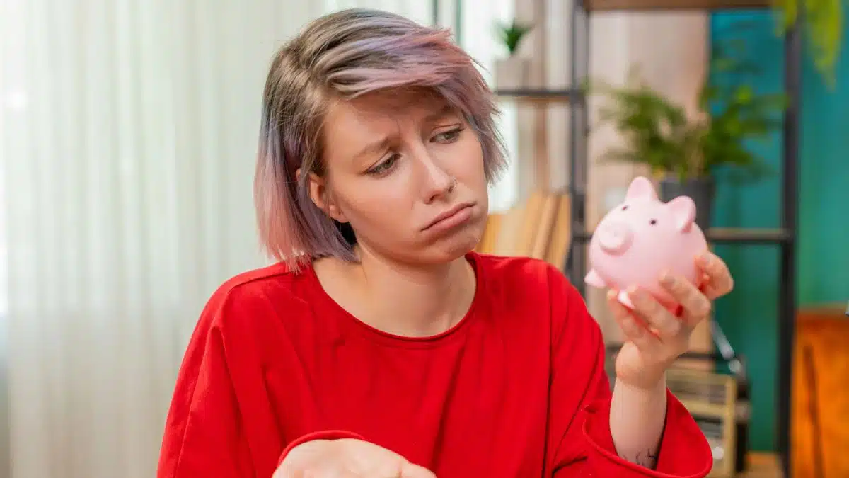 sad woman holding a piggy bank
