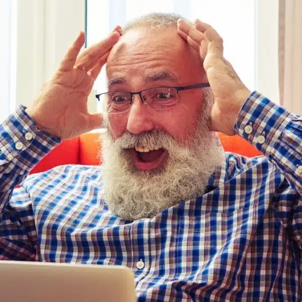 senior man shocked about his results on laptop