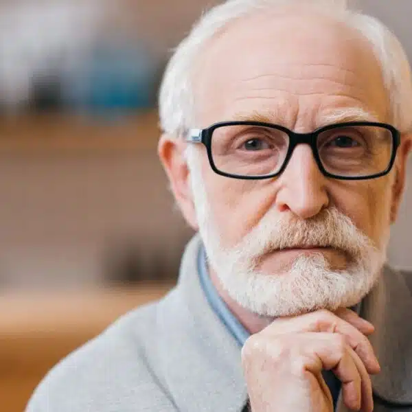 senior man thinking at home