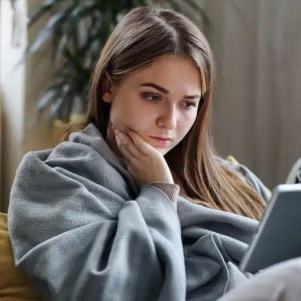 woman at home staring at her tablet