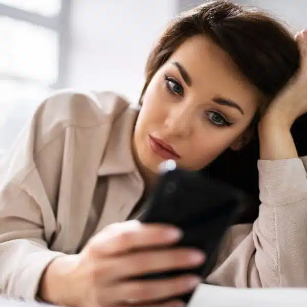 woman confused looking at her phone