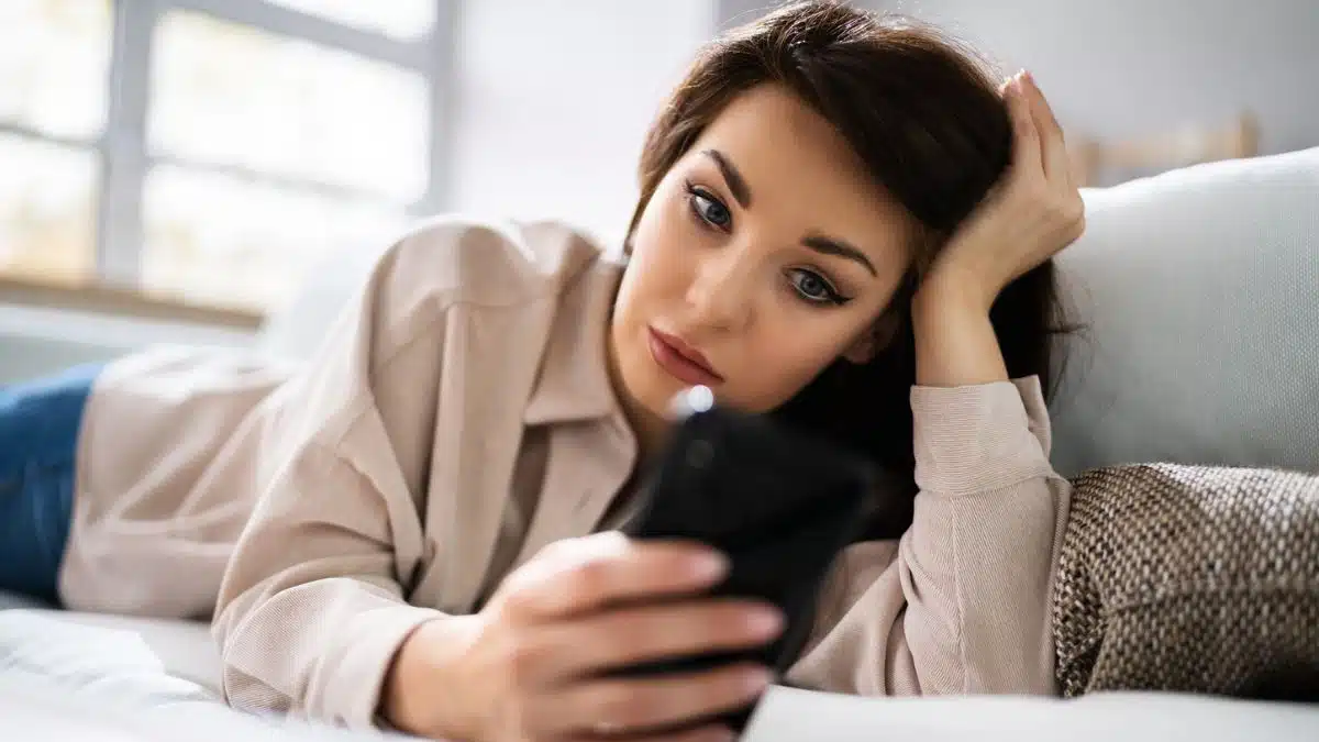 woman confused looking at her phone