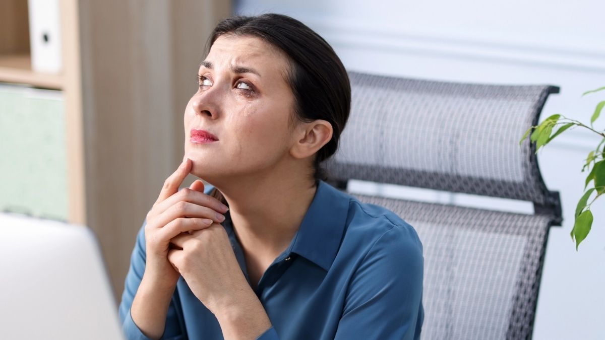 woman crying in her office