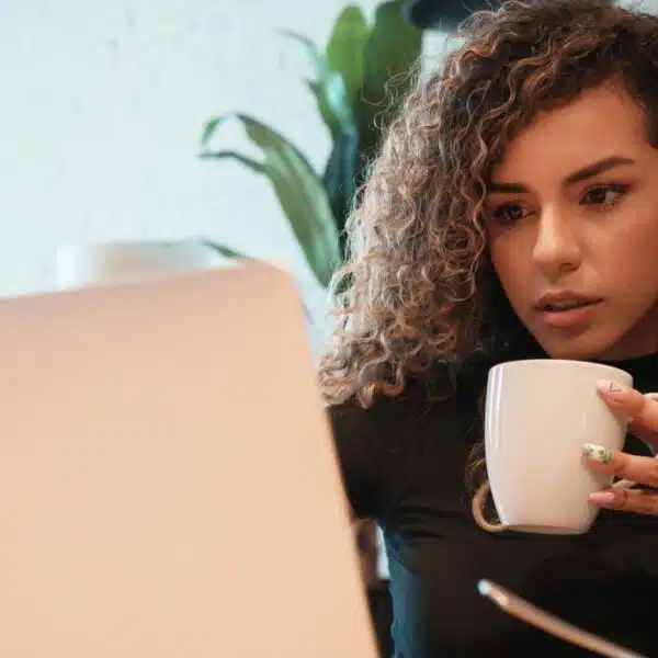 woman drinking coffee and working from home