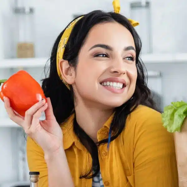 woman holding up a tomato