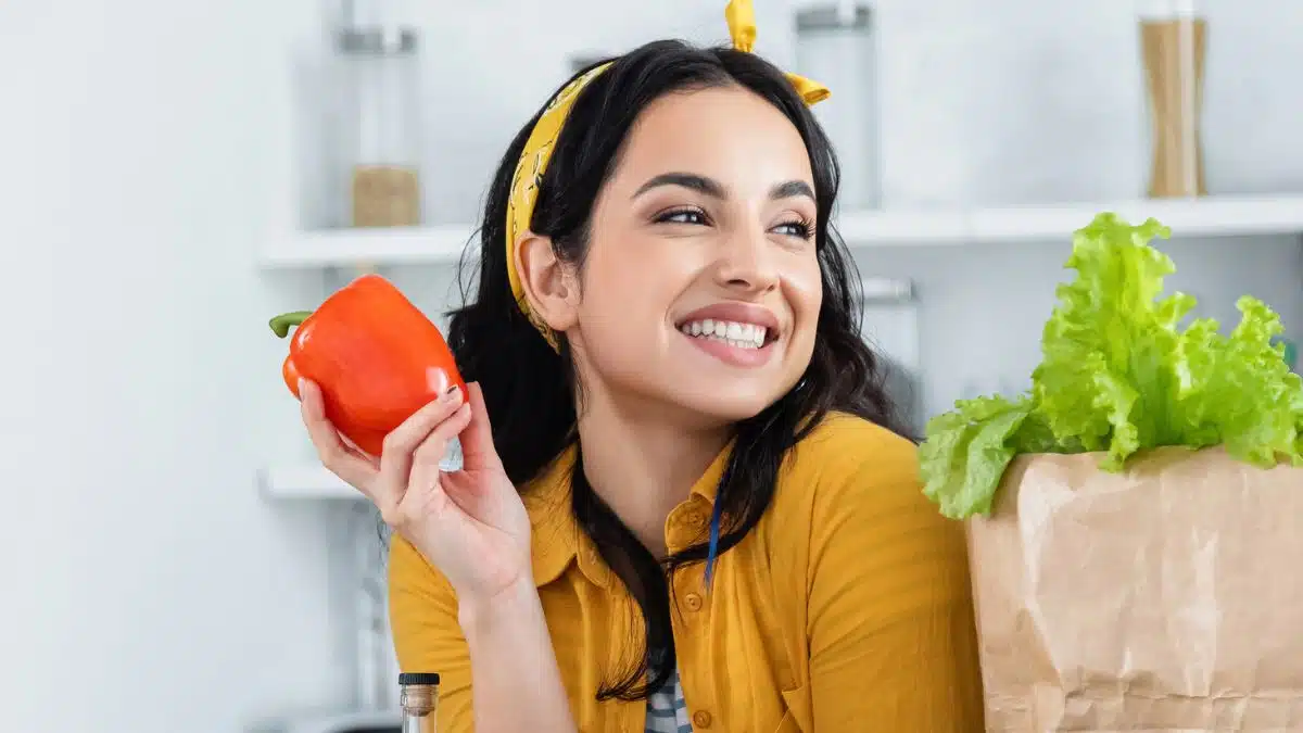 woman holding up a tomato