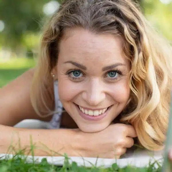 woman in a park laying down phone