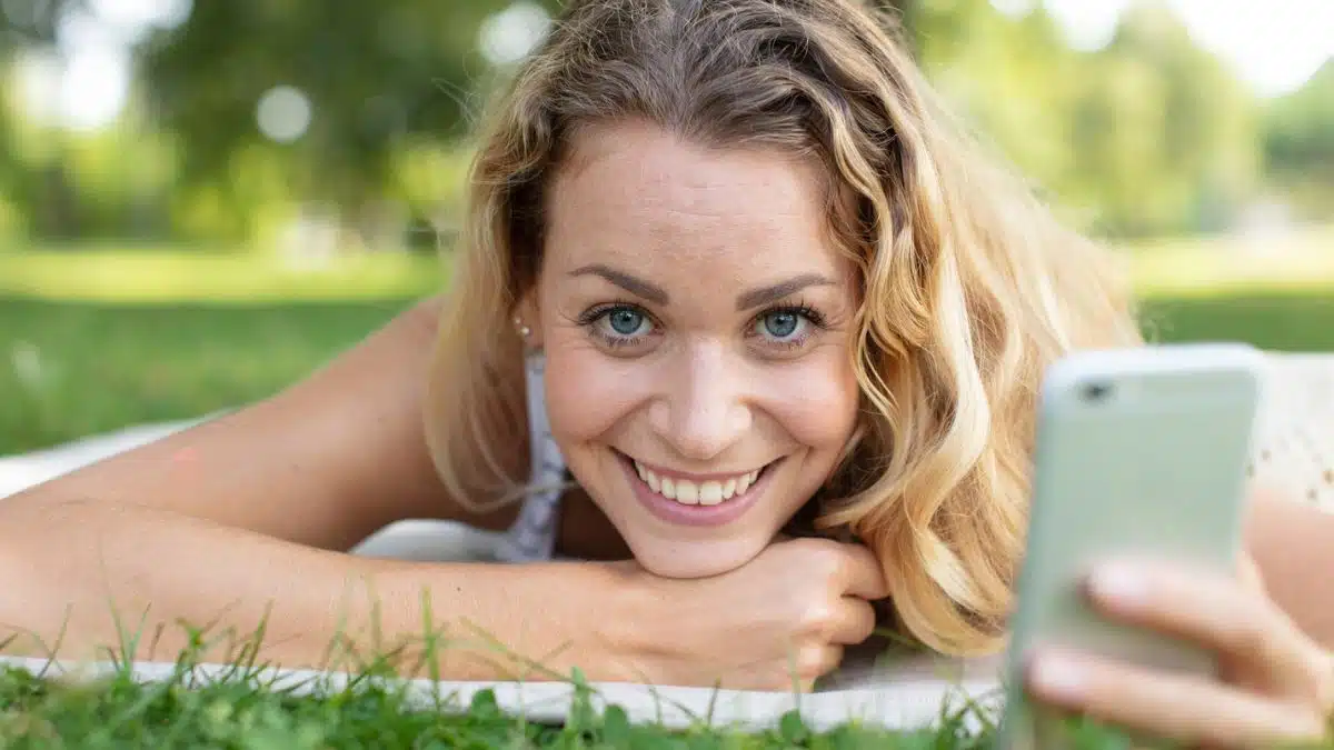 woman in a park laying down phone