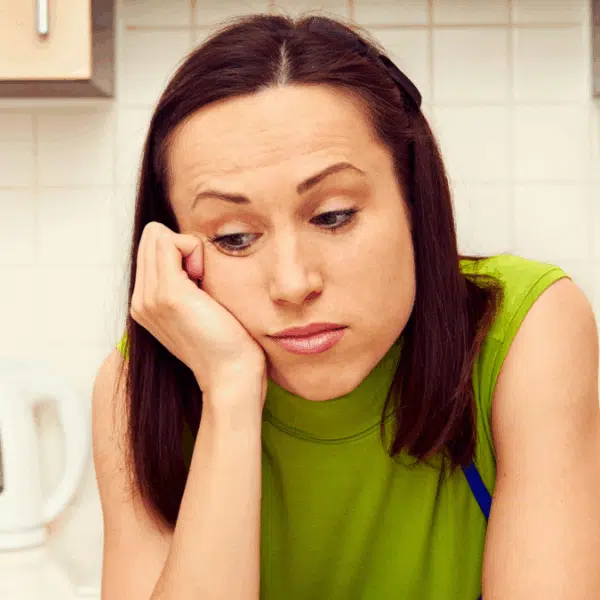 woman sad in her kitchen