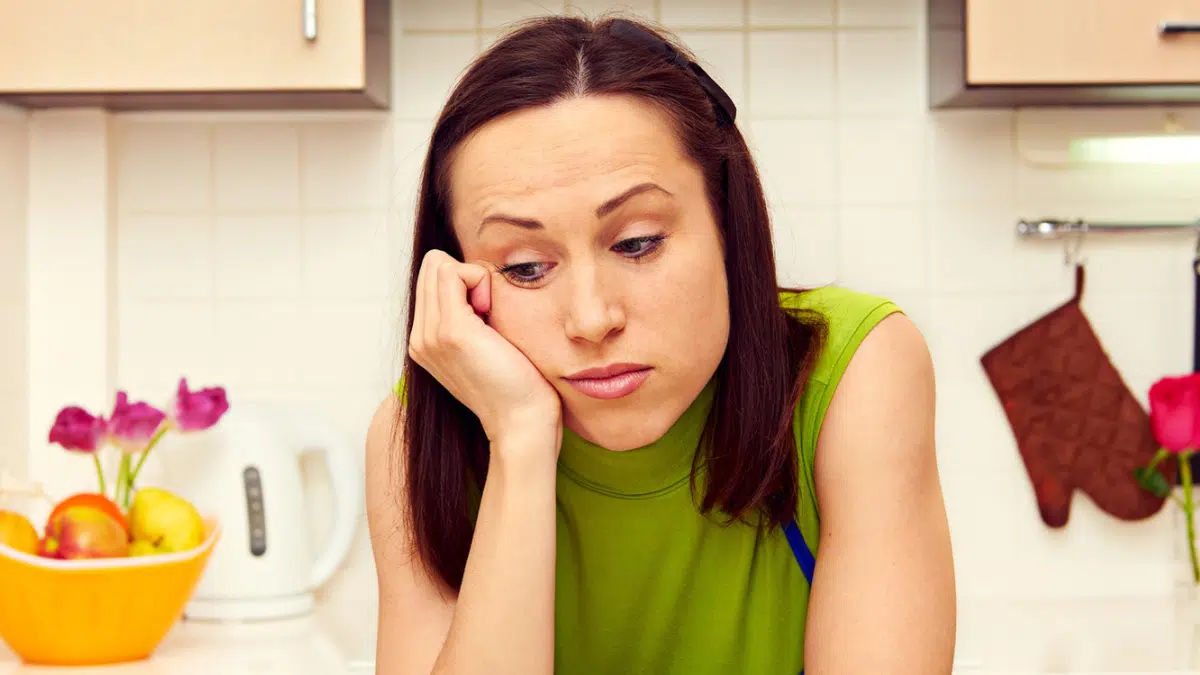 woman sad in her kitchen