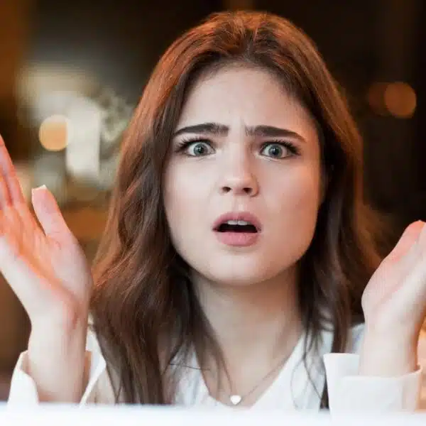 woman shocked looking at her laptop