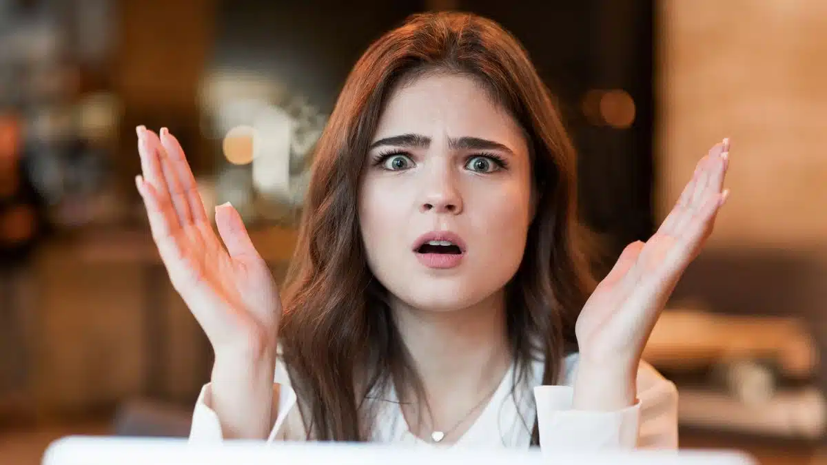 woman shocked looking at her laptop