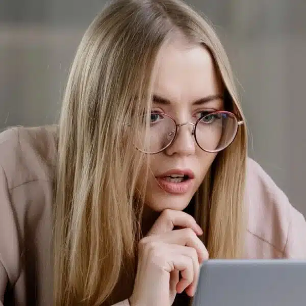 woman shocked reading on her laptop