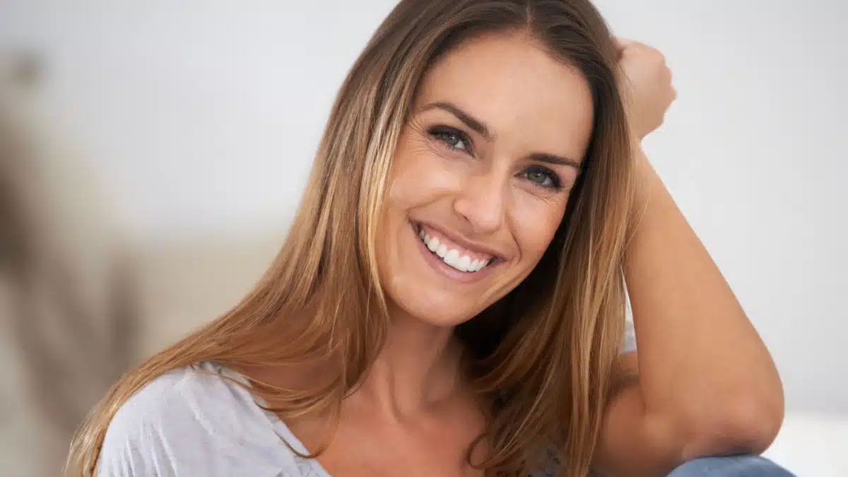 woman smiling at home sitting on couch