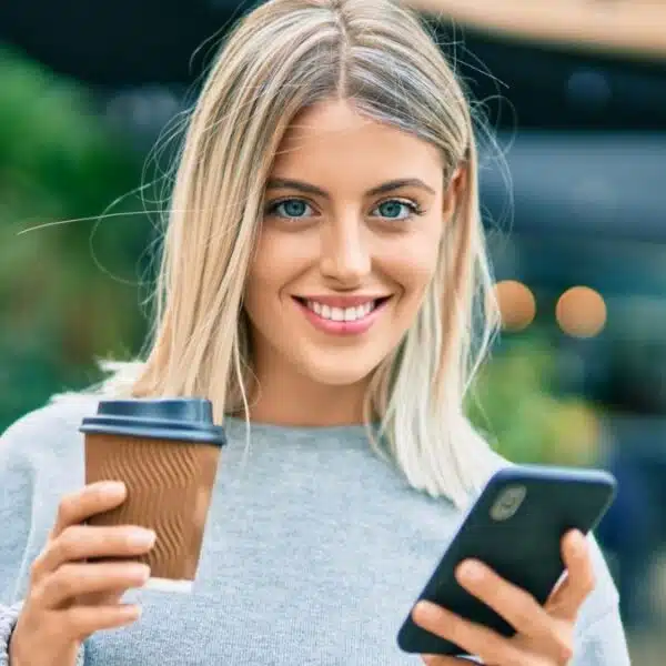 woman smiling with her coffee