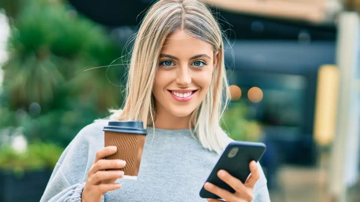 woman smiling with her coffee