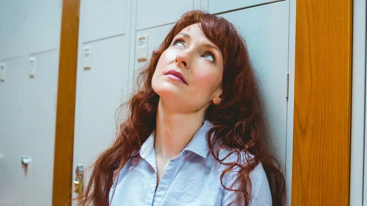 woman standing at a locker